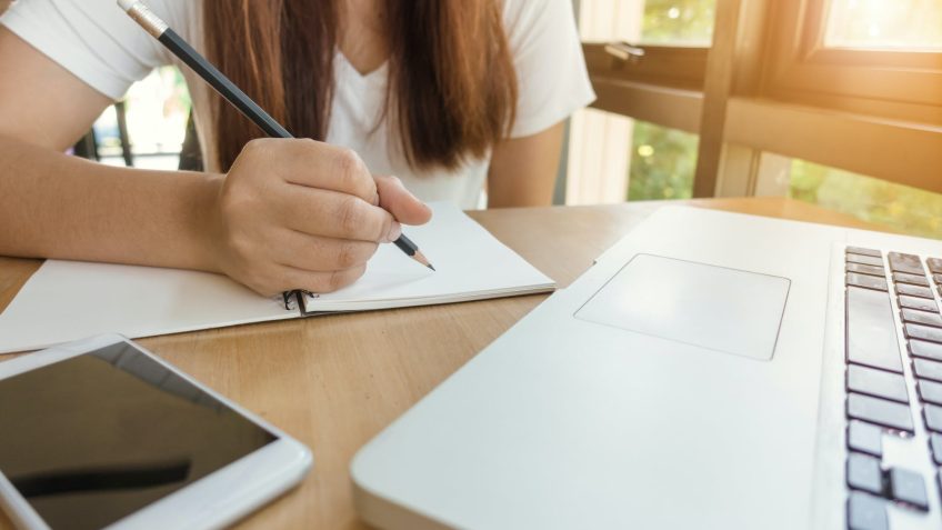 woman about to write on paper
